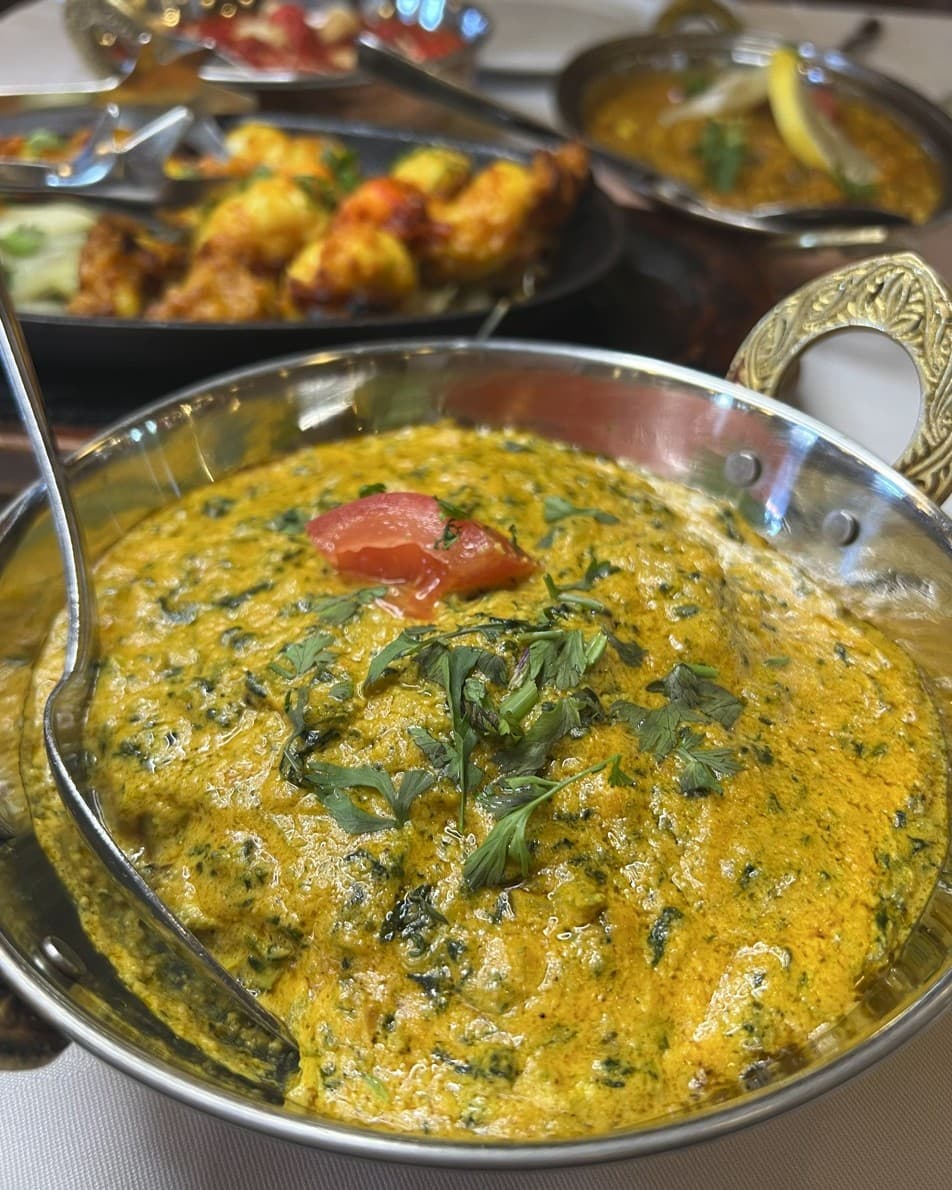 Creamy saag curry close-up in a copper balti
